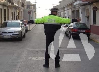 Un agente con los dos brazos extendidos horizontalmente...